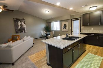 A kitchen with a white sofa and a countertop.
